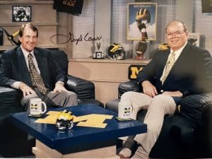 Lloyd Carr, Jim Brandstatter are posing for a picture